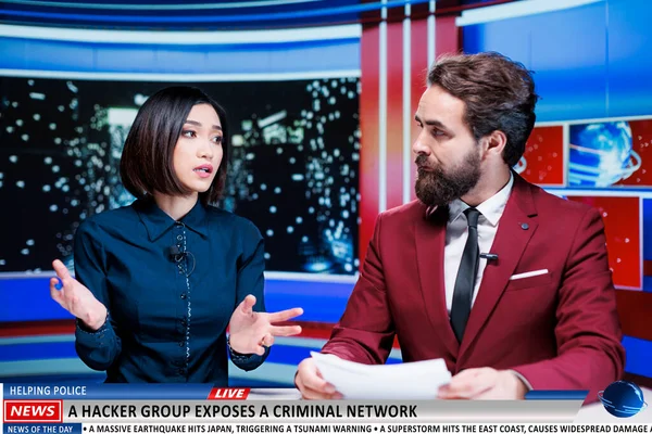 Reporters present hackers helping police in exposing and catching criminal network, live television broadcast. Diverse team of journalists discuss about cyberbullying headlines, news segment.