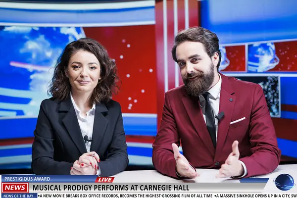 Presenters team announce new concert, famous artist hosting musical performance at historical hall in newsroom. Journalists reporting live on morning show, leisure event in town.