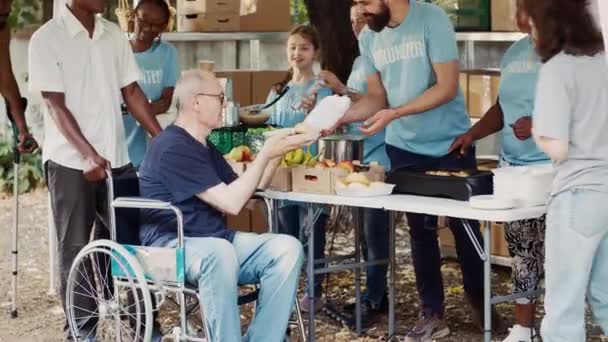 慈善组织致力于与饥饿和贫穷作斗争 向无家可归的人提供免费食物 温饱食品由志愿者提供给那些坐轮椅的加卡人 但他们的特权较低 — 图库视频影像