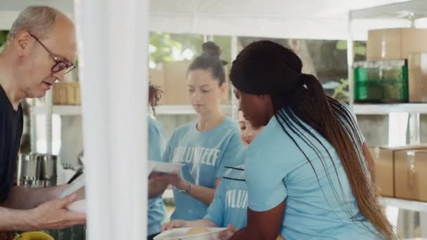 Young Charity Workers Serving Fresh Food Those Need Offering Support — Stock Video