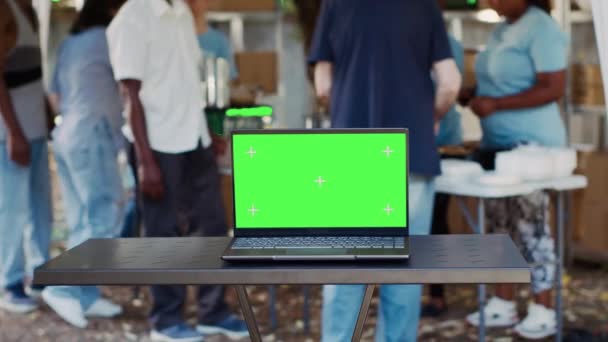 Digital Laptop Blank Green Screen Display Placed Table While Volunteers — Stock Video