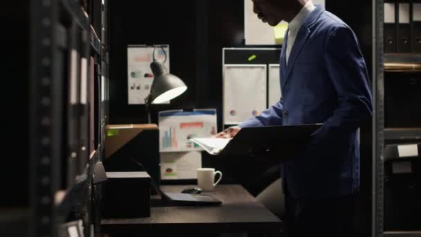 African American Detective Inspects Evidence Well Organized Office Focused Solving — Stock Video