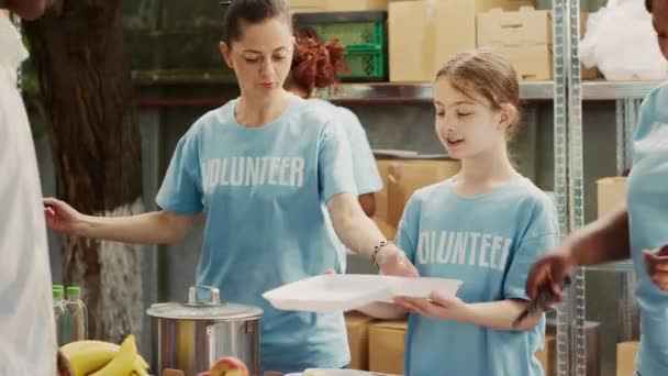 Focus Caucasian Mother Daughter Helping Out Food Drive Distributing Free — Stock Video