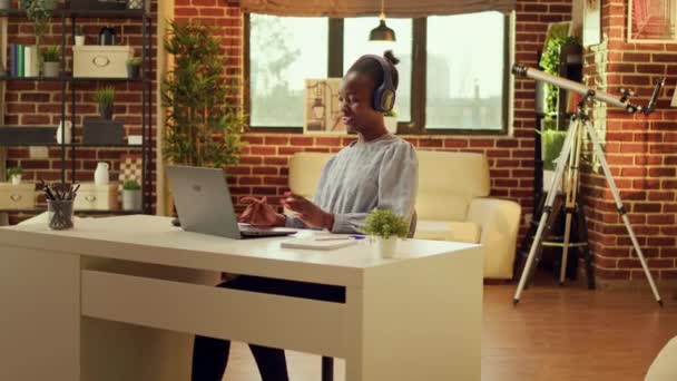 편안한 여자는 음악을 스테이션에서 노트북에 정보를 입력합니다 아프리카계 미국인 워커는 — 비디오
