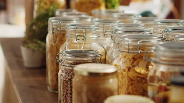 Close up on bulk products in recyclable glass containers used by zero waste supermarket to eliminate single use plastics. Local store pantry staples in sustainable packaging, zoom out shot