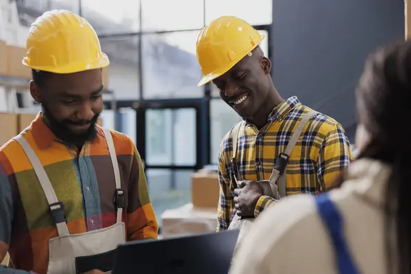 Warehouse Workers Wearing Yellow Helmets Laughing Chatting Work Smiling African — Stock Photo, Image