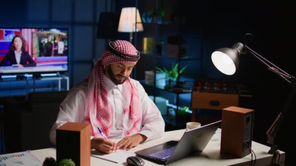 Muslim Man Home Paying Attention Elearning Seminar Teleconference Teacher Writing — Stock Video