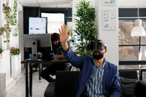 Business worker using vr technology for project presentation in startup company workplace. Entrepreneur wearing virtual reality headset to simulate product design and development