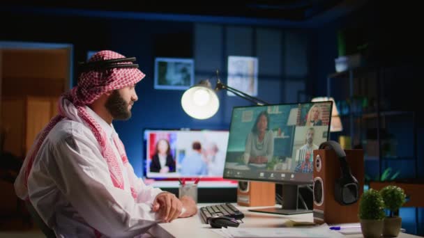 リモートで働く同僚とのオンラインテレコンファレンスミーティングのアラブ人男性 タスクの進捗についてチャット ビデオコール中にプロジェクトの同僚と話し合う自宅から働くイスラム教徒の従業員 — ストック動画