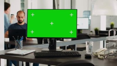 Boş ofis çalışma istasyonunda yeşil ekranlı bilgisayar masaüstü, küçük işletme işyerindeki kopyalama alanı kromatonunu gösteren model ekran. Monitörde izole görüntü, eşçalışma alanı.
