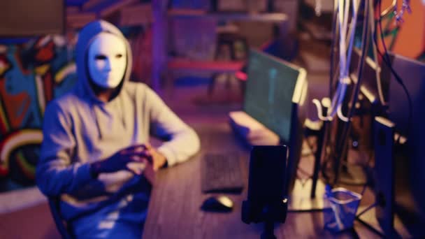 Hacker Wearing Anonymous Mask Threatens Victim Deploying Malware Designed Exploit — Stock Video