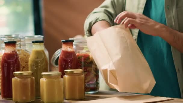 在纸袋中加入意大利面以购买足够的营养晚餐 从可循环利用的容器中从大宗产品中选择有机食品 顾客去买食物 手持射击 — 图库视频影像