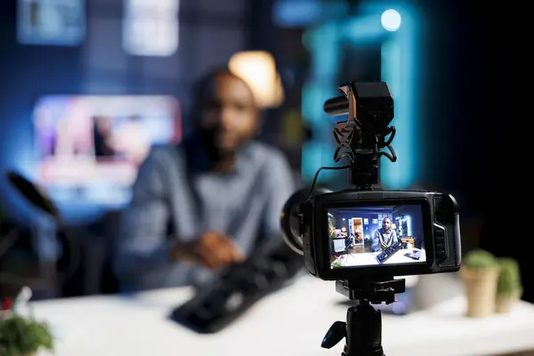 stock image Focus on professional video production gear used for capturing footage of audio engineer in blurry background filming DJ tutorial for niche viewership, showcasing disc jockey turntables