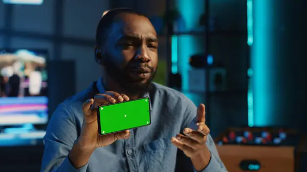 Content creator in studio films newly released chroma key smartphone video review for tech enthusiasts. Viral online star hosts technology internet show, unboxing isolated screen cellphone