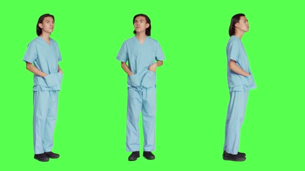 Egészségügyi Dolgozó Várja Zöldhasú Hátteret Orvosi Egyenruhában Áll Zaklatottan Viselkedik — Stock videók