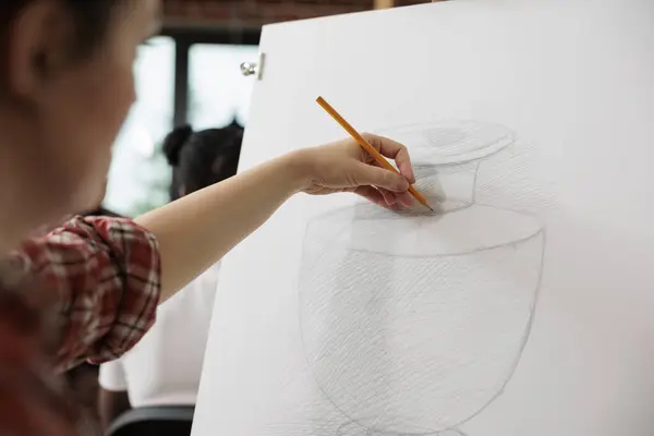 Creative process. Female artist sketching and shading vase with pencil, learning to draw and sketch at art school, woman enjoying drawing as hobby attending creative workshop to develop creativity