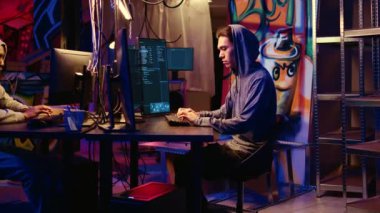 Graffiti boyalı bodrumda çalışan Asyalı hacker portresi. Sistem sahiplerine karşı fidye olarak kullanılacak sistem savunmasızlıkları için kahramanlıklar arıyor. Yakın çekim.
