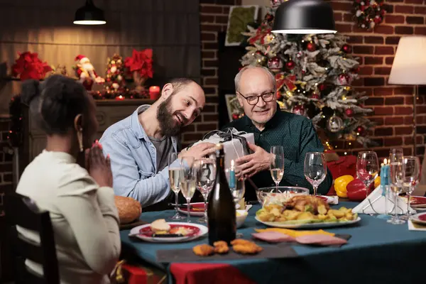 Two Men Exchanging Gifts Christmas Dinner Diverse People Offering Present — Stock Photo, Image