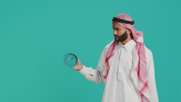 Arab Guy Sees Wall Clock Check Time Camera Using Timepiece — Stock Video