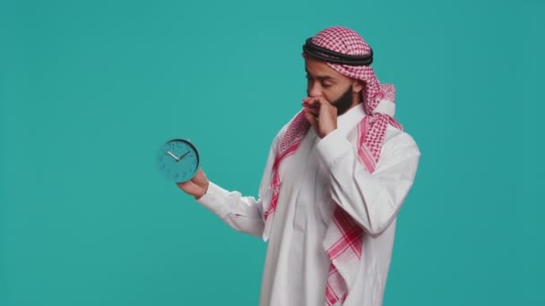 Islamic Adult Looks Wall Clock Check Time Camera Using Timepiece — Stock Video