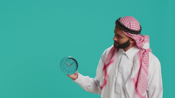 Arab Man Looks Wall Clock Check Time Studio Using Timepiece — Stock Video