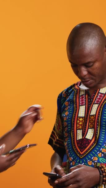 Vertical Video Традиционная Африканская Пара Просматривает Веб Сайты Смартфоне Проверяет — стоковое видео
