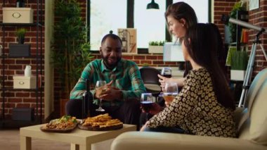 Afrikalı Amerikalı bir adamın, arkadaşlarıyla gülen, alkollü içkilerle kadeh kaldıran, özel bir olayı sıcak bir dairede kutlayan portresi. Şık bir evde iş arkadaşları kaynaşıyor.