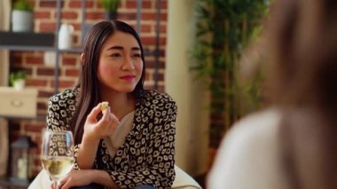 Asyalı kadın çok ırklı apartman partisi konukları arasındaki ilginç tartışmaya dikkat ediyor. Şarküteri kurulundan gurme peyniri yemek ve arkadaşlarının konuşmasını dinlemek.