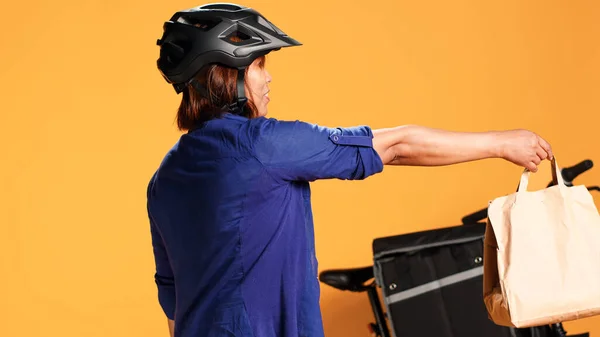 Close Delivery Bike Rider Greeting Customer Offering Takeout Meal Bag — Stock Photo, Image