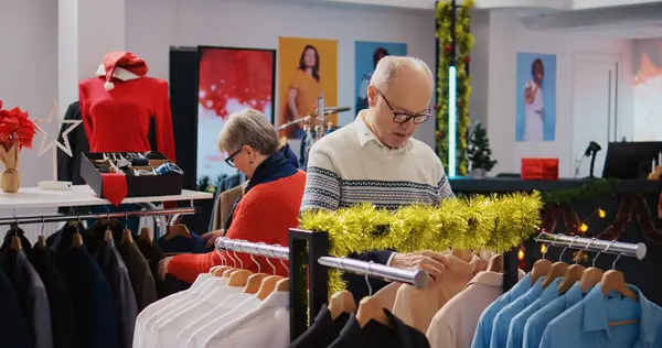 Zmysłowych Klientów Przeglądających Regały Odzieżowe Świątecznym Butiku Ozdabiającym Modę Podczas — Zdjęcie stockowe