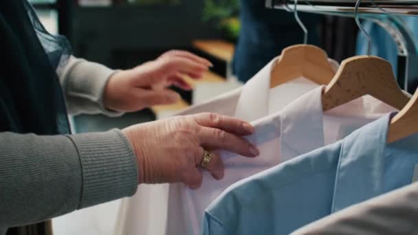 Senior Kvinna Bläddrar Genom Hängare Med Eleganta Skjortor Letar Efter — Stockvideo