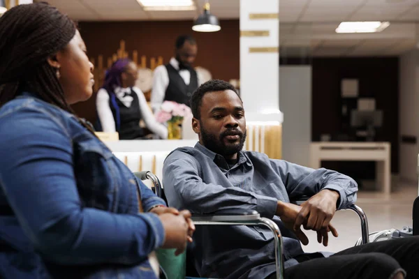Young African American Man Wheelchair Hotel Lobby Able Bodied Girlfriend — Stock Photo, Image