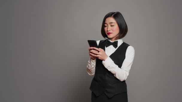 Pekerja Industri Perhotelan Menggunakan Aplikasi Smartphone Melalui Latar Belakang Abu — Stok Video