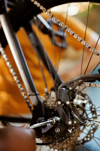近距离人员使用专家工作工具调整和安全自行车踏板和链条 黑色女用扶手固定自行车部件的详细照片 按键为年检用 — 图库照片
