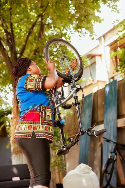 Active Sports Loving African American Lady Ensures Bike Wheel Secure — Stock Photo, Image
