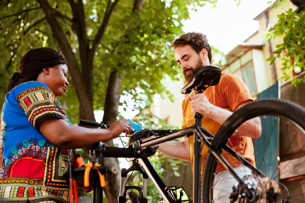 Healthy African American Lady Assisting Her Caucasian Boyfriend Fix His — Stock Photo, Image