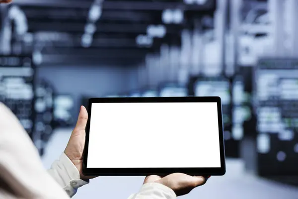 Stock image Close up shot of mock up tablet used by professional in server room delivering massive computing power, capable of processing and storing vast amounts of data and controlling network resources