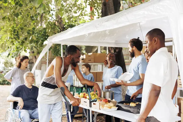 Caring Charity Workers Serve Warm Meals Less Privileged Outdoors Aiding — Stock Photo, Image
