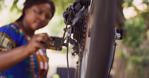 Enthusiastic African American Female Cyclist Carefully Examining Fixing Damaged Bicycle — Stock Photo, Image
