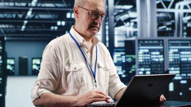 Trained engineer expertly managing data while navigating in industrial server room. Specialist ensuring errorless cybersecurity protection, optimizing systems and performing necessary updates clipart