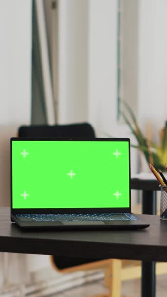 緑色のスクリーン ラップトップが付いている縦のビデオ オフィスおよびスケジュールされた顧客のリストが付いている背景の表示 ワークスペースと顧客の財務コンサルティングリストのモックアップノート — ストック動画