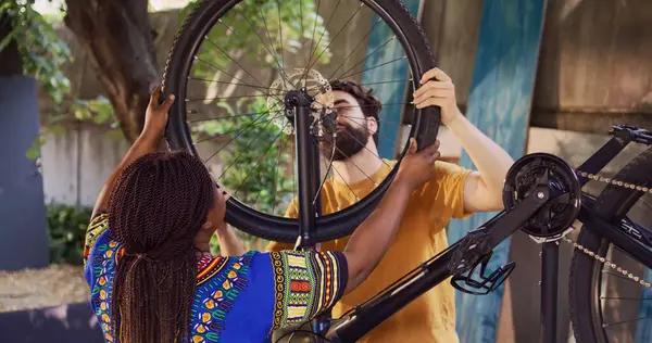 Active Sporty Interracial Couple Safely Securing Front Bicycle Tire Repair — Stock Photo, Image