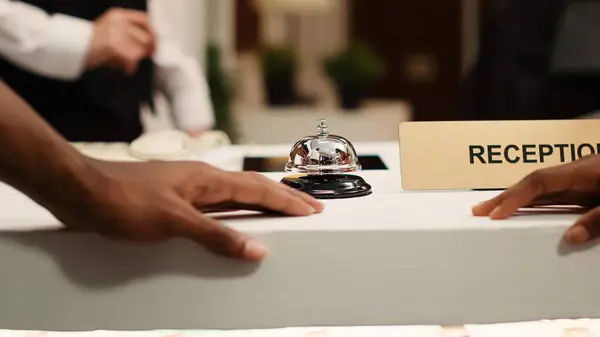 Close African American Guests Ringing Concierge Bell Reception Counter Check — Stock Photo, Image