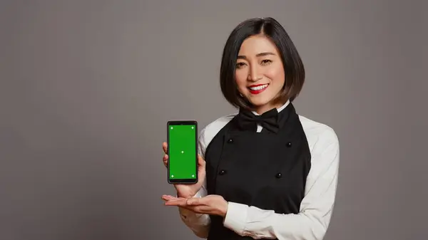 Restaurant Hostess Presenting Smartphone Greenscreen Showing Isolated Display Chromakey Layout — Stock Photo, Image