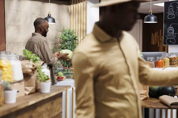 Young Black Man Handing Cabbage Shopkeeper Checkout Counter Fresh Healthy — Stock Photo, Image