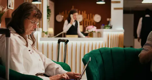 Senior Couple Passing Time Lounge Area Woman Using Laptop Create — Stock Photo, Image