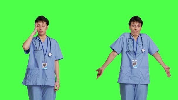 Orvosi Asszisztens Akinek Fejfájása Van Zavarodottságot Jelez Zöld Háttér Előtt — Stock videók