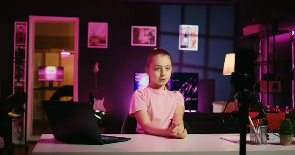 stock image Zoom in shot of innocent little girl shooting video for social media platform in living room, talking about her day. Kid entertaining fans, doing content creation using professional recording tech