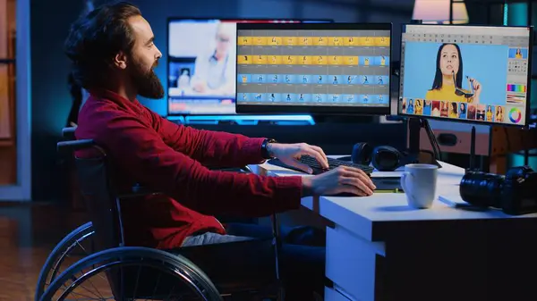 stock image Photo editor in wheelchair working for independent production company, adjusting white balance on overexposed pictures. Paralyzed photographer with handicap in creative agency editing pictures