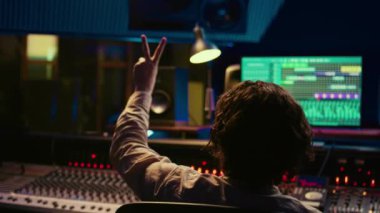 Ses mühendisi, ses kabinindeki sanatçıların yeni müzik, kontrol odası teknik ekipmanları üretmeye başlaması için geri sayım yapıyor. Yetenekli ses teknisyenleri, hareket düğmeleri ve sürgüler. Kamera B.